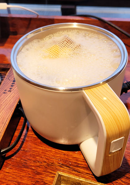 Makgeolli cooking in a pot.